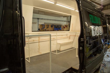 Inside Susan curry's vehicle conversion, during the internal build. The hatch is shown.