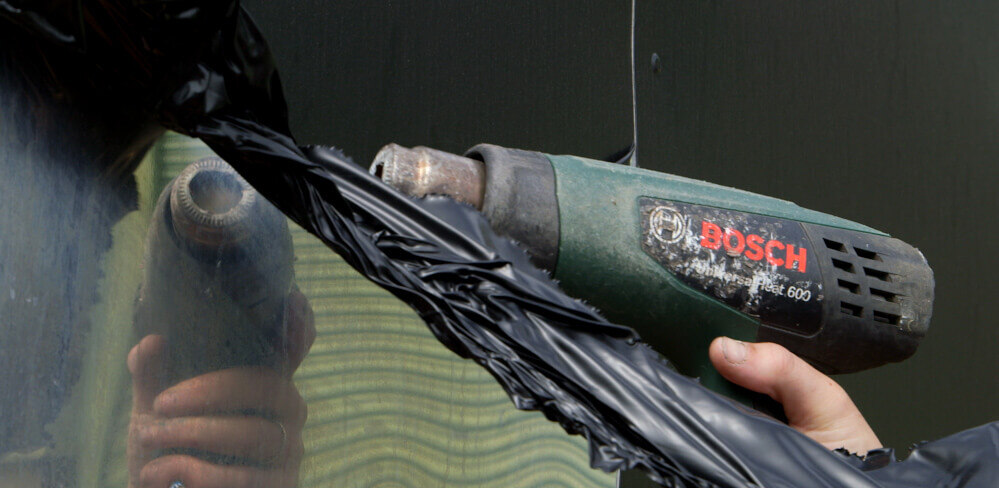 Using a heat gun to remove a vehicle wrap